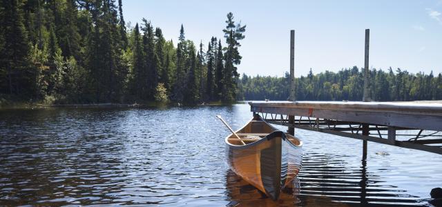 Canoe tied to a dock on a lake in northern Minnesota